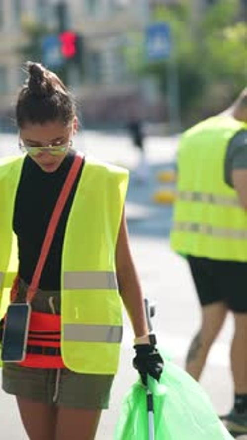 Young Adult Cleans Street in Urban Setting