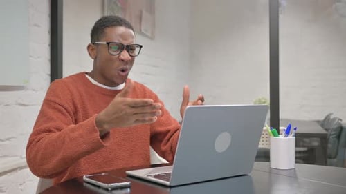 Man Upset While Using Laptop in Office