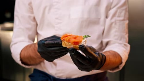 Chef Prepares Salmon Appetizer in Modern Kitchen
