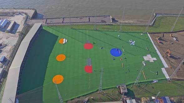 Rising aerial of waterfront golf driving range at O2 area of London ...