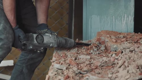 Dismantling a Brick Wall with a Perforator Closeup