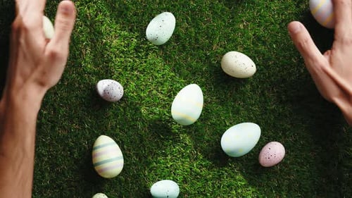 Hands Collecting Colorful Easter Eggs