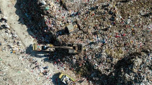Large Waste Dump and Trash Truck with Garbage in Aerial Top View Time Lapce