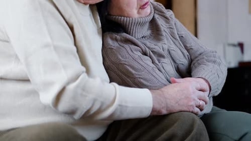 Senior Couple Embracing Affectionately at Home