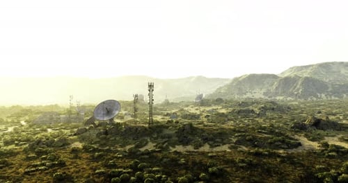 Communication Towers Stand Tall Against a Vast Mountainous Landscape at Dawn