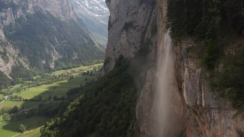 Aerial of stunning waterfall pouring of high mountain
