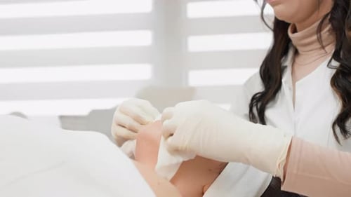 Woman Receiving Facial Treatment in a Bright Spa