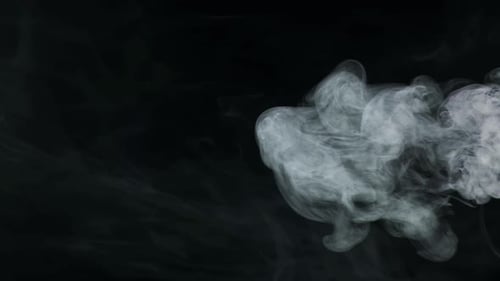 Billowing White Smoke Rising on Black Background