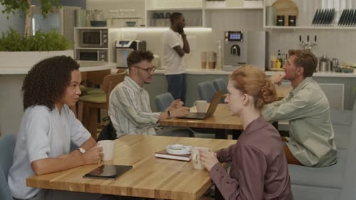 Young Diverse People Cooperating in Coworking Office