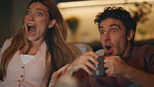 Emotional Pair Watching Television at Night Flat Closeup Couple Reacting Film