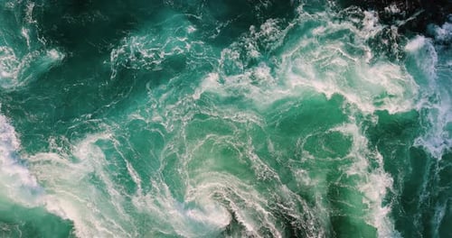 Blue waves of water of the river and the sea meet each other during high tide and low tide.