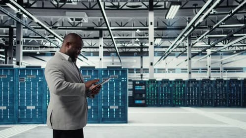 Programmer in Data Center Using Tablet to Manage Software Updates