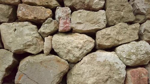 An Old Stone Wall Made of Stones of Different Sizes Smoothly Changes Its Position Creating an
