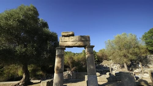 Kounos ancient city in Dalyan Turkey. Camera goes under Ancient Greek stone archway. 4K.