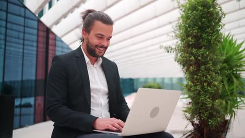 Businessman Sitting Outside with Laptop Working Remote Distant Job Outdoors Near Office
