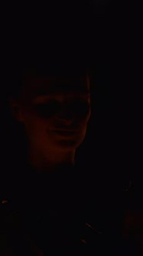 Mystical Fire Performer Moving in Darkness with Glowing Flames Creating Dramatic Light Trails and