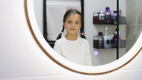 Adorable Young Girl with Missing Teeth in Bathroom Portrait