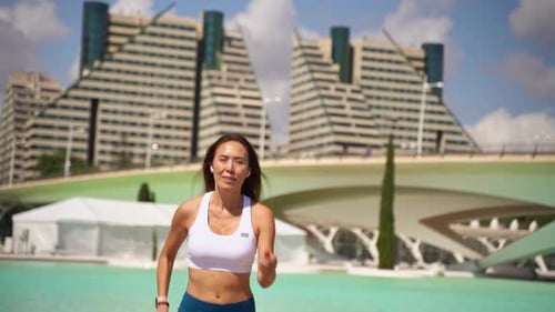 Fit Woman Jogging in the City on Sunny Day