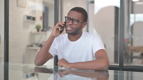 Man Talking on Phone at Work