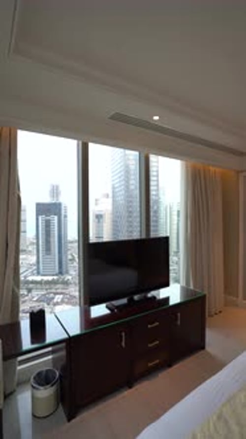 Modern Hotel Room Entertainment Setup with City Skyline View