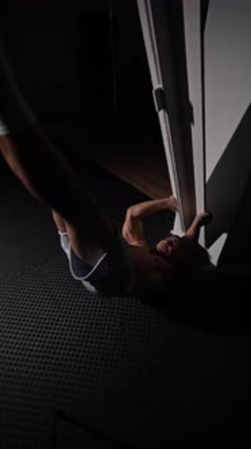 Muscular Man Doing Fitness Exercises in Dark Room