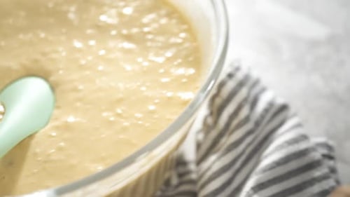 Frying Coconut Banana Pancakes on a Nonstick White Frying Pan