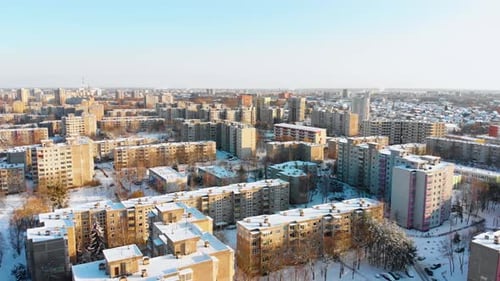 Aerial view of apartments houses in winter, snowy environment, sunny day, flying above apartments ho