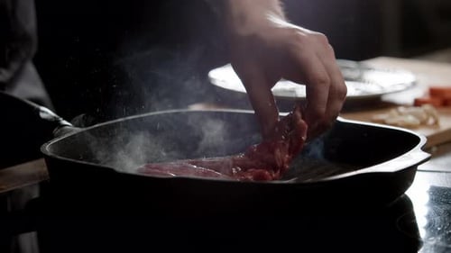 Chef Cooks Steak In Steaming Grill Pan
