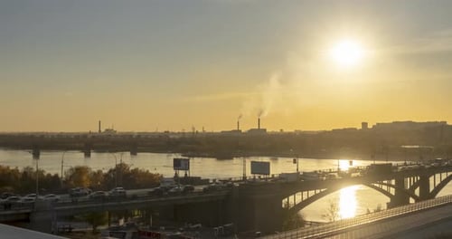 Timelapse of City Life Sun Rays Blue Sky River and Bridge Over Horizont Traffic Jam at Summer Sunset