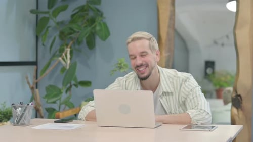 Man Video Conferencing on Computer