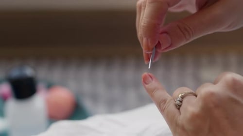 A Beautiful Woman Applying Nail Polish To Her Fingernails 2