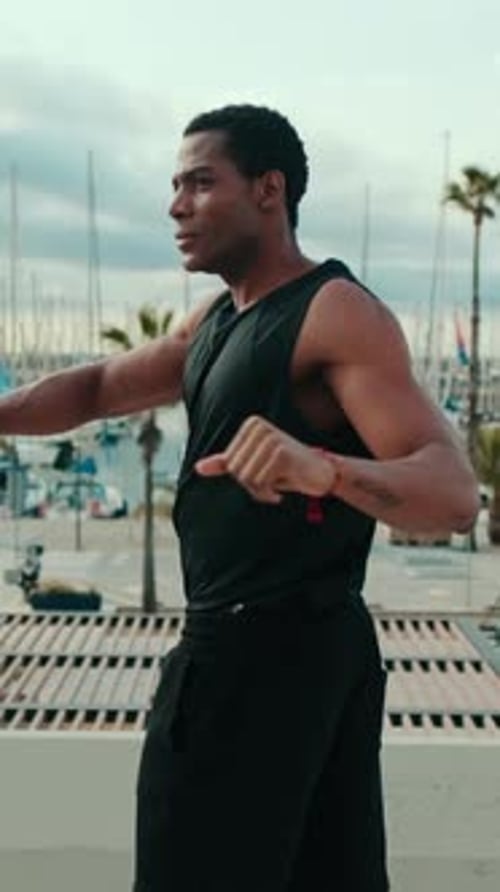 Vertical video, Muscular Black Man Overlooking Marina