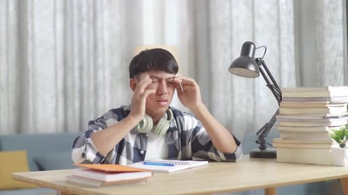 Tired Teenager Having Headache While Learning At Home