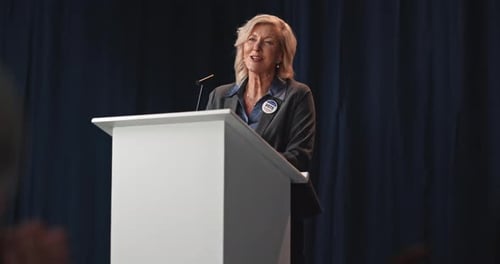 Woman Giving Speech at Podium
