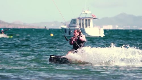 Sportsman practicing kite surf sport at the beach on a windy day at the Spanish coasts