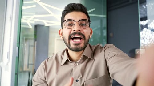 Cheerful Man Explains Technology in Modern Office