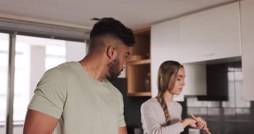 Young Couple Cooking Together in Modern Kitchen