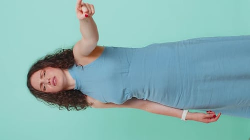Woman in Blue Dress Gesturing and Directing