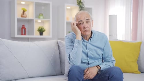 Old man looking thoughtfully at camera.