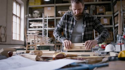 Bearded man working on a woodworking project