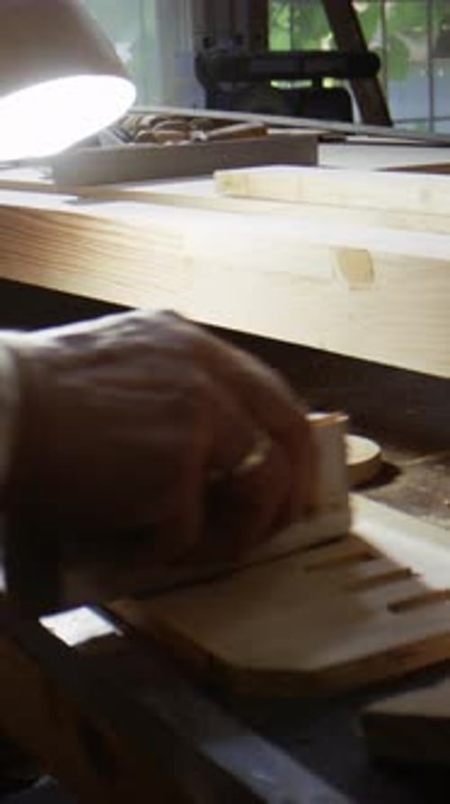 Man Sands Wood Surface with Block Tool Focusing on Precision