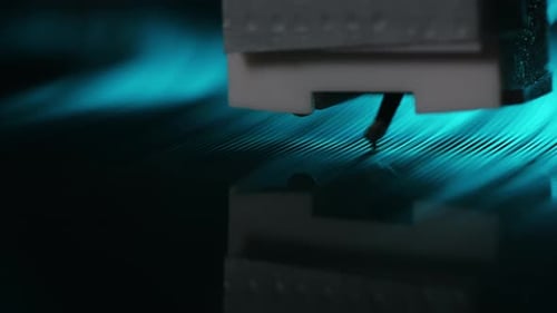 Record Player Stylus on Vinyl Record with Blue Light
