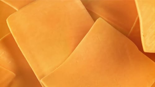 Slices of Cheddar Cheese Fly and Fall Filmed on a Highspeed Camera at 1000 Fps