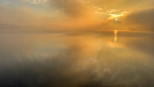 A Beautiful Sunset Reflected in the Calm Surface of the Lake