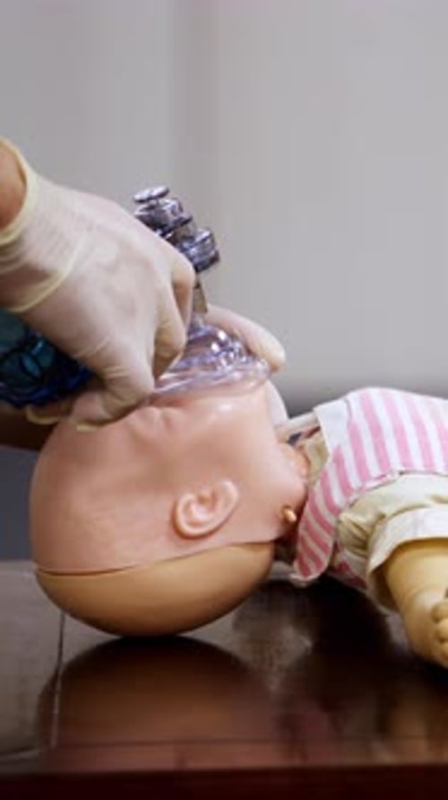 Healthcare Professional Demonstrates Infant CPR Techniques