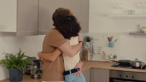 Loving Couple Embracing in Kitchen