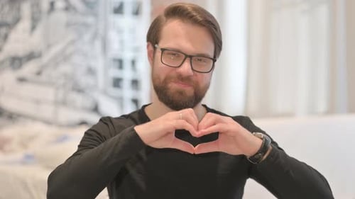 Man Making Heart Shape With Hands