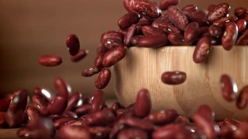 Red Kidney Beans Falling from Wooden Bowl