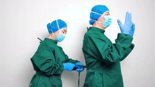Medical staff doctor Nurse and assistant dressing surgeon gown in surgery room