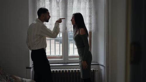 Candid couple fighting, man pointing finger blaming for problems, pushing her away and girlfriend hi